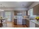 Well-lit kitchen features wood floors, painted cabinets, gas range, and a dining table at 12241 Cypress Way, Fayetteville, GA 30215