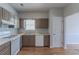 Practical kitchen with wood floors, neutral cabinets, gas range, and a double basin sink at 12241 Cypress Way, Fayetteville, GA 30215