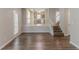 Bright living room with wood floors, staircase, and open view into the kitchen at 12241 Cypress Way, Fayetteville, GA 30215