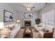 Bright living room featuring a fireplace, ceiling fan, and neutral color scheme at 12241 Cypress Way, Fayetteville, GA 30215