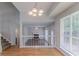 Open living room with hardwood floors, fireplace, and ample natural light at 12241 Cypress Way, Fayetteville, GA 30215