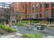 Inviting courtyard with a cozy fireplace, comfortable seating, and beautiful landscaping, perfect for relaxation and entertaining guests at 170 Boulevard Se # 115E, Atlanta, GA 30312