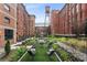 Stunning courtyard featuring a fire pit, comfortable seating, and lush landscaping, all set against a backdrop of beautiful brick buildings at 170 Boulevard Se # 115E, Atlanta, GA 30312