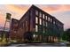 Exterior view of red brick building with large windows against a sunset sky at 170 Boulevard Se # 115E, Atlanta, GA 30312