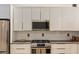 Modern kitchen with stainless steel appliances, white cabinets, and stylish backsplash at 170 Boulevard Se # 115E, Atlanta, GA 30312