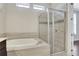 Elegant bathroom features a soaking tub, glass enclosed shower, and stylish tile work at 3005 Devoncroft Se St, Smyrna, GA 30080