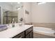 Well-lit bathroom featuring a sleek vanity, modern fixtures, and a separate shower and tub at 3005 Devoncroft Se St, Smyrna, GA 30080