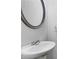 Powder room featuring a pedestal sink, mirror, and modern fixtures at 3005 Devoncroft Se St, Smyrna, GA 30080