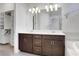 Bathroom with double sink vanity, large mirror, modern lighting and fixtures, with walk-in closet at 3005 Devoncroft Se St, Smyrna, GA 30080