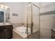 Bathroom featuring a soaking tub, glass shower, and modern finishes at 3005 Devoncroft Se St, Smyrna, GA 30080