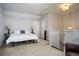 Spacious bedroom with neutral carpet, a large bed, and staircase access, offering a relaxing retreat at 3005 Devoncroft Se St, Smyrna, GA 30080