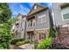 Stylish townhome with stone facade, gray siding, and a cozy front patio at 3005 Devoncroft Se St, Smyrna, GA 30080
