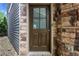 Close-up of a brown front door with stone surround, adding charm to the entrance at 3005 Devoncroft Se St, Smyrna, GA 30080
