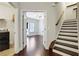 Hallway with hardwood floors, stairs, laundry room and a view to the living room at 3005 Devoncroft Se St, Smyrna, GA 30080