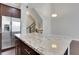 Kitchen with island and granite counters, stainless steel refrigerator and dark wood cabinets at 3005 Devoncroft Se St, Smyrna, GA 30080