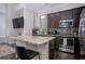 Modern kitchen with granite countertops, stainless steel appliances, and dark wood floors at 3005 Devoncroft Se St, Smyrna, GA 30080