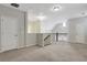 Open-concept living room with neutral carpet, overhead lighting, and a railing at 3005 Devoncroft Se St, Smyrna, GA 30080