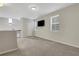 Bright living room with large windows, a mounted TV, and neutral carpet at 3005 Devoncroft Se St, Smyrna, GA 30080