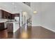 Open-concept space with high ceilings, kitchen with stainless steel appliances, and beautiful hardwood floors at 3005 Devoncroft Se St, Smyrna, GA 30080