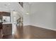 Open space with high ceilings, hardwood floors, stairway to second story, and view of kitchen at 3005 Devoncroft Se St, Smyrna, GA 30080