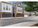 Charming townhomes featuring stone accents, gray siding, and attached two-car garages at 3005 Devoncroft Se St, Smyrna, GA 30080