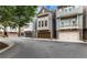 Charming townhomes featuring stone accents, gray siding, and attached garages at 3005 Devoncroft Se St, Smyrna, GA 30080