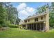 Large backyard with lush green grass, a screened porch, and mature trees perfect for outdoor activities and relaxation at 878 Park Creek Sw Ct, Marietta, GA 30064