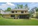 Back of house and sprawling lawn leading to the screened-in porch, perfect for outdoor gatherings and relaxation at 878 Park Creek Sw Ct, Marietta, GA 30064