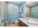 Cozy bathroom features a vanity with a sink and wood cabinets, as well as tiled walls and a window for natural light at 878 Park Creek Sw Ct, Marietta, GA 30064