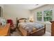 Comfortable bedroom with a window offering natural light and closet at 878 Park Creek Sw Ct, Marietta, GA 30064