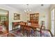 Classic dining room with wood table, chairs, chandelier, and hardwood floors with a decorative rug at 878 Park Creek Sw Ct, Marietta, GA 30064