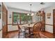 Cozy dining area features wood floors, a round table, and large window with views of greenery at 878 Park Creek Sw Ct, Marietta, GA 30064