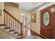 Elegant foyer featuring hardwood floors, staircase, and a decorative front door with glass detailing at 878 Park Creek Sw Ct, Marietta, GA 30064