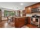 Cozy kitchen nook with wood cabinets, stainless steel appliances, and a breakfast table with natural light at 878 Park Creek Sw Ct, Marietta, GA 30064