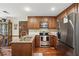 Well-equipped kitchen with wooden cabinets, stainless steel appliances, and granite countertops with breakfast area at 878 Park Creek Sw Ct, Marietta, GA 30064