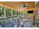 This charming screened-in porch is perfect for entertaining with a ceiling fan and views of the outdoor landscape at 878 Park Creek Sw Ct, Marietta, GA 30064