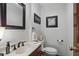 Neat half bath featuring an attractive framed mirror, decor and fixtures at 878 Park Creek Sw Ct, Marietta, GA 30064