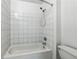 Bathroom with white tiled walls and a shower-tub combination at 881 Memorial Se Dr # 307, Atlanta, GA 30316