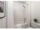 Clean bathroom featuring a white tiled shower, modern fixtures, and a well-maintained design at 881 Memorial Se Dr # 307, Atlanta, GA 30316