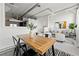 Open-concept dining area features wood table, black chairs, and kitchen view, perfect for modern living at 881 Memorial Se Dr # 307, Atlanta, GA 30316