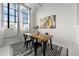 Bright dining area with large windows, wood table, and black chairs, perfect for modern living at 881 Memorial Se Dr # 307, Atlanta, GA 30316