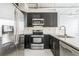 Modern kitchen boasts stainless steel appliances, dark cabinets, and stone countertops at 881 Memorial Se Dr # 307, Atlanta, GA 30316