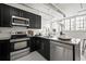 Stylish kitchen featuring black cabinetry, stainless steel appliances, and granite countertops, ideal for cooking at 881 Memorial Se Dr # 307, Atlanta, GA 30316
