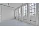 Stylish living area with tall windows and flowing curtains, showcasing bright, airy ambiance of the loft at 881 Memorial Se Dr # 307, Atlanta, GA 30316