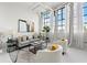 Bright living room with large windows, white brick walls, and modern decor offers a spacious urban feel at 881 Memorial Se Dr # 307, Atlanta, GA 30316