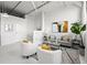 Bright living room with large windows, white brick walls, and modern decor offers a spacious urban feel at 881 Memorial Se Dr # 307, Atlanta, GA 30316