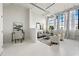 Bright living room with large windows, white brick walls, and modern decor offers a spacious urban feel at 881 Memorial Se Dr # 307, Atlanta, GA 30316
