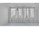 Spacious living room with tall windows and white curtains, offering plenty of natural light and a modern chandelier at 881 Memorial Se Dr # 307, Atlanta, GA 30316