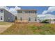 View of the back of the house showing a deck and spacious backyard in new construction at 17 Camellia Dr, Fairburn, GA 30213