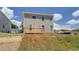 Back of the house with a wooden deck in backyard on a sunny day at 17 Camellia Dr, Fairburn, GA 30213